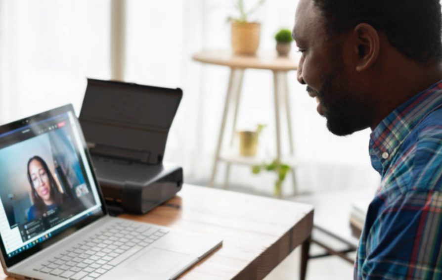 Man on computer facetiming with a woman