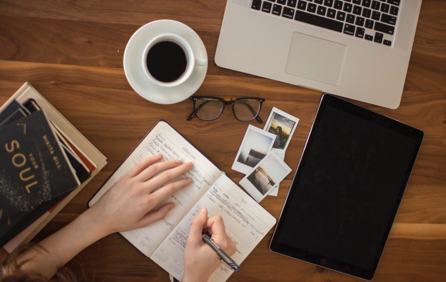 Independent plans content for batch with coffee, notebook, photos, and laptop.