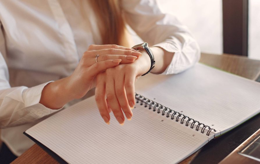 Woman checking her watch to manage her time properly
