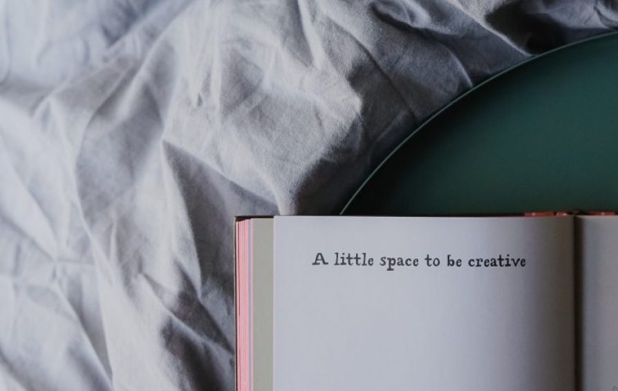 a book and a grey blanket