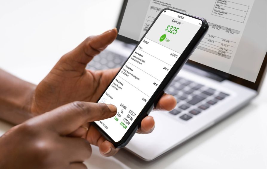Person paying an invoice on a phone with a transaction fee