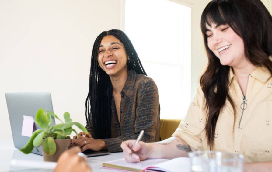 Group of women sitting at a table smiling