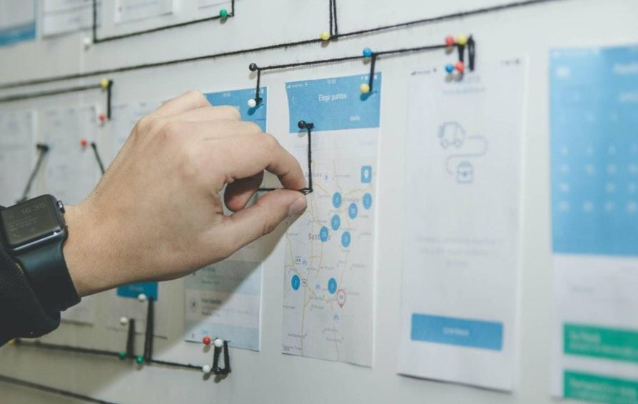 Person using workflow mapping on a bulletin board