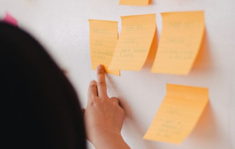 sticky notes of various colors stuck onto a whiteboard