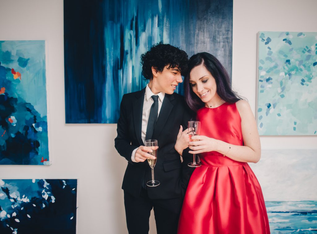 Couple drinking champagne at an art gallery