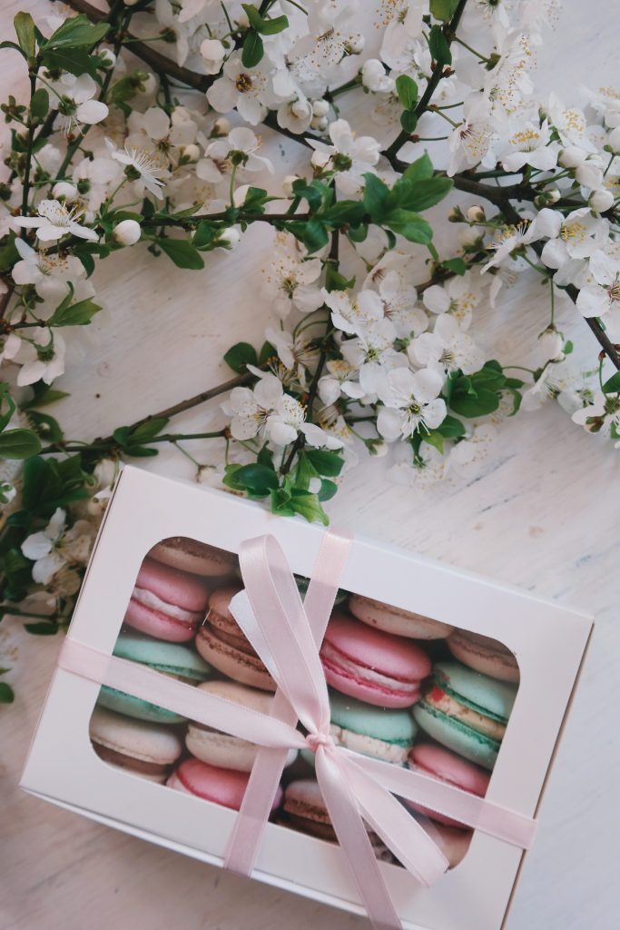 a table with macaroons and flowers
