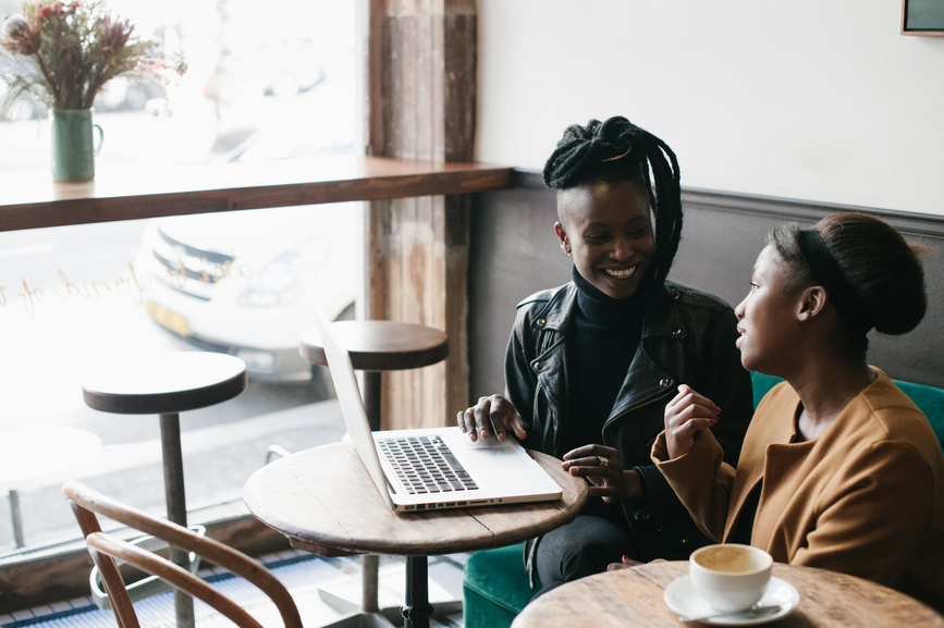 Two women writing a polite payment reminder email