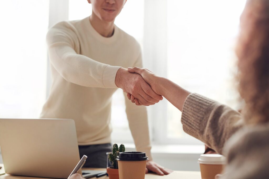 Businessman shaking hands with a client they just won with a sales proposal