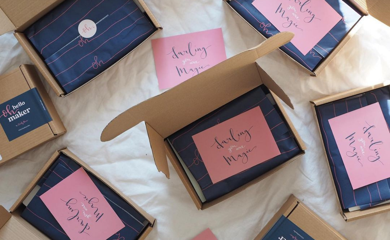 Multiple client gift boxes open and showing personalized thank you notes